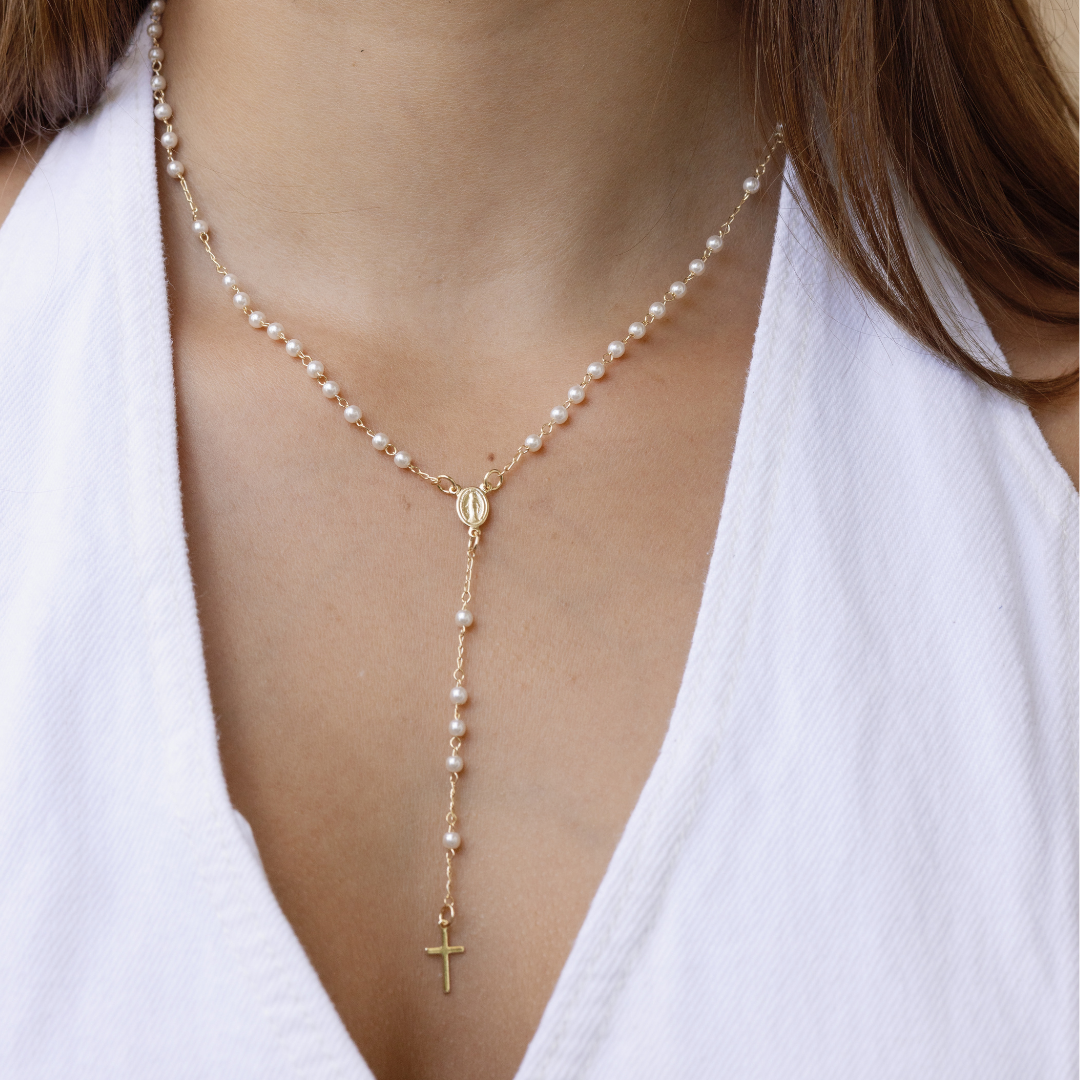 Pearl rosary styled with gold faith jewelry