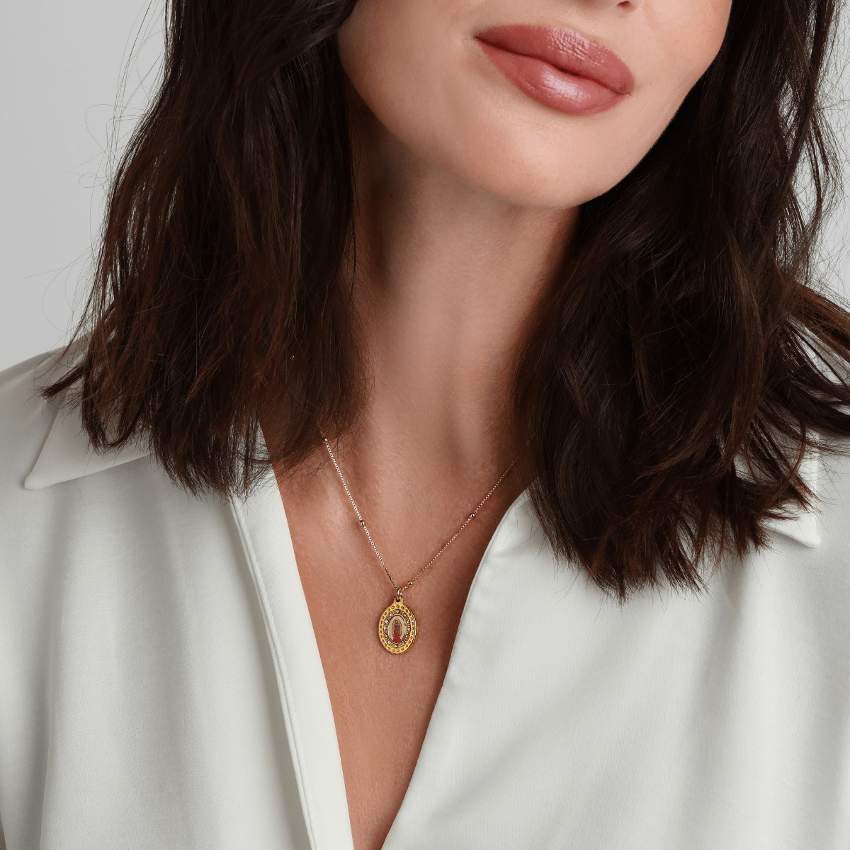 La Mer pendant necklace styled with layered gold jewelry