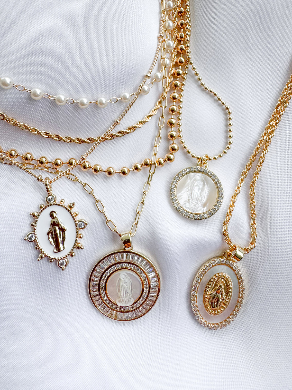 Gold-tone Marian pendant necklaces displayed together for layering