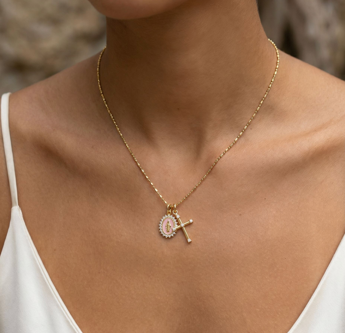 Baby pink Virgin Maria multi-charm necklace styled with gold jewelry