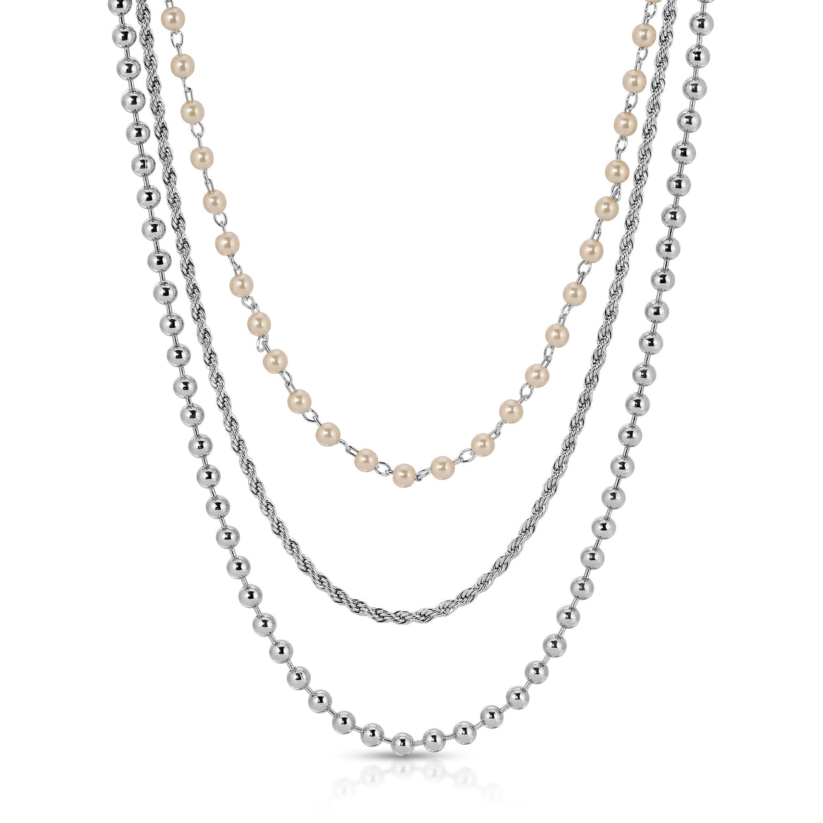 Close-up of the Pearl Trio necklace with layered gold chains
