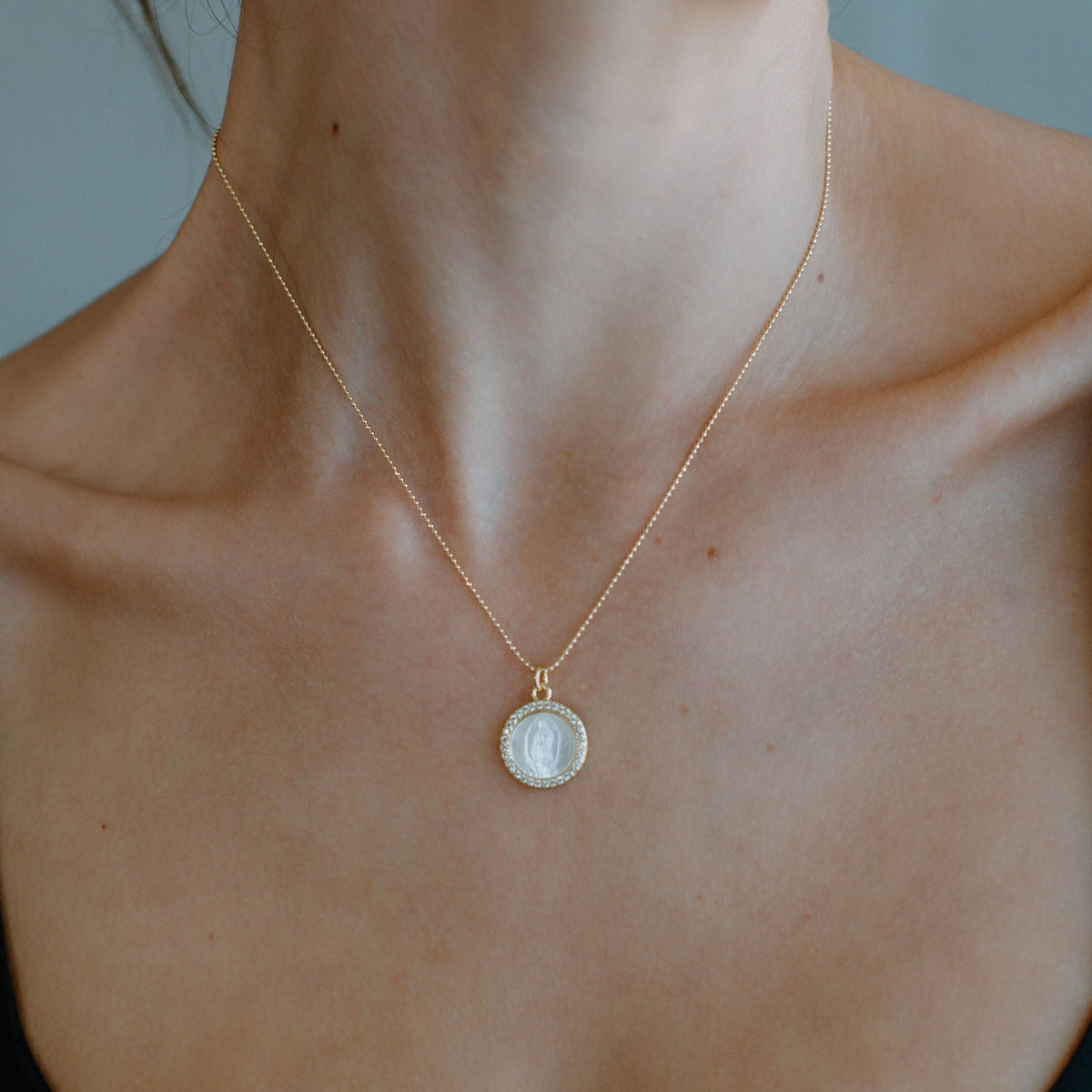 Close-up of the Petite Mother Mary pendant and gold chain