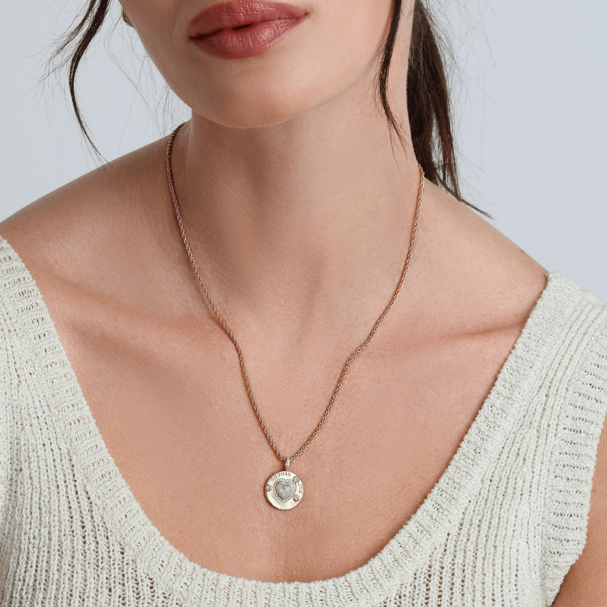 Joyful Heart necklace styled with layered gold jewelry