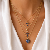Joy Dravecky layered gold necklace styling with blue stone pendants