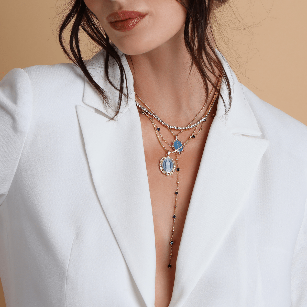 Layered gold faith jewelry featuring French blue Marian details