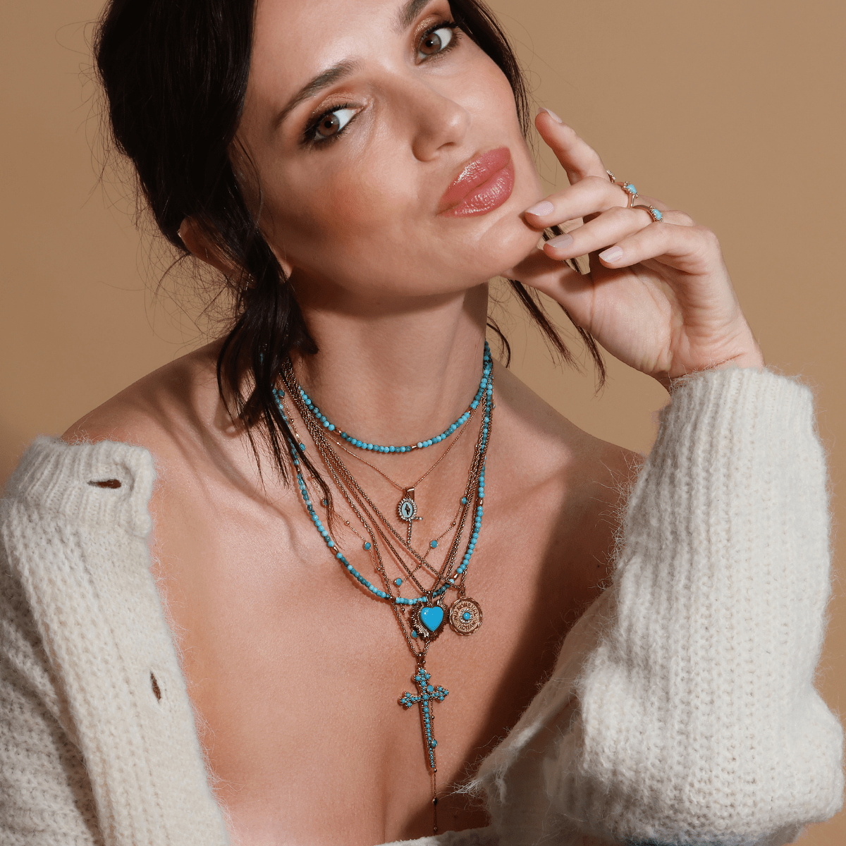 Aqua Virgin Maria multi-charm necklace styled with gold jewelry