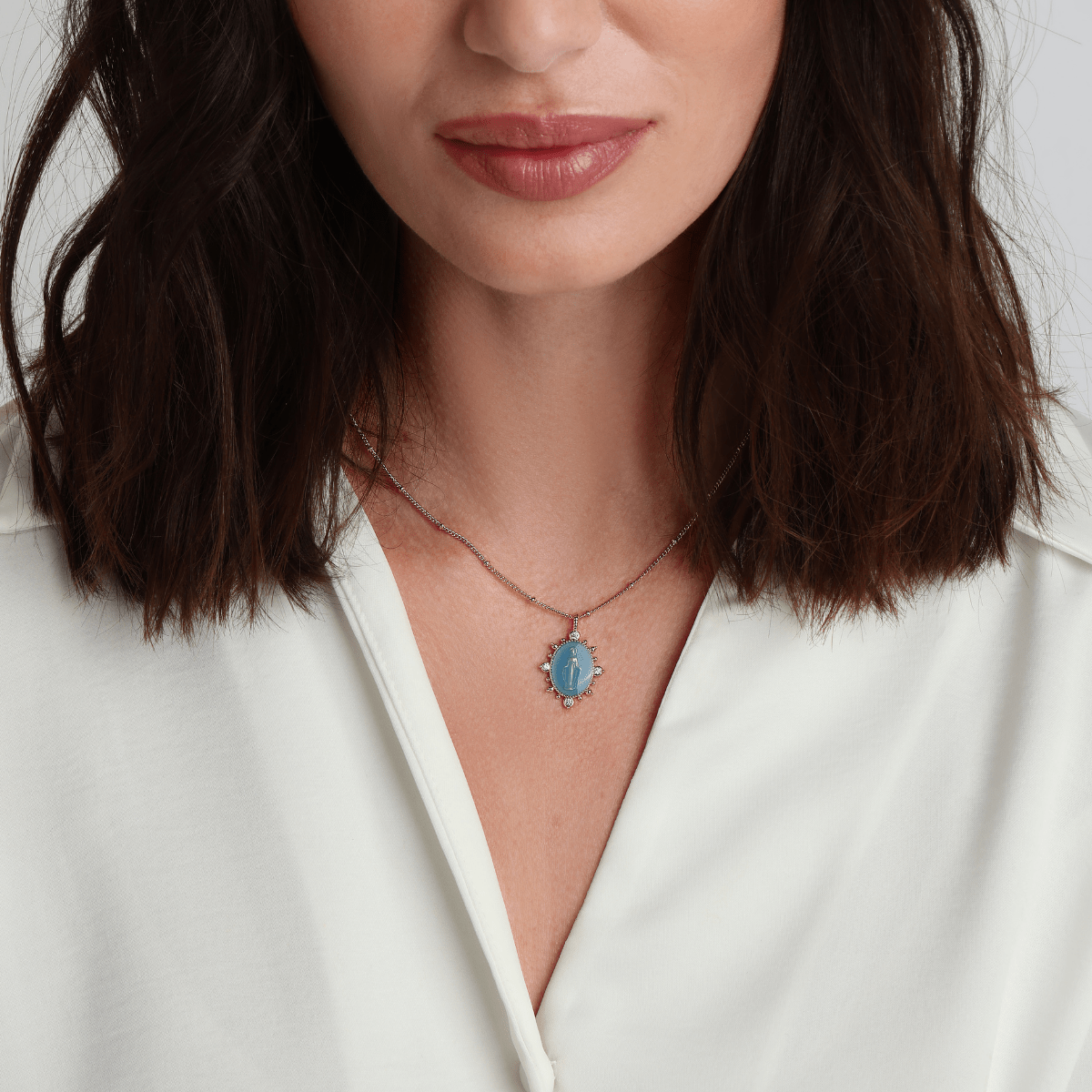 French Blue Lady Lourdes necklace styled with layered gold jewelry