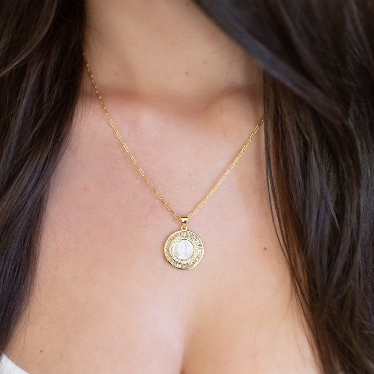 Mother Mary pearl necklace worn on its own with a white top