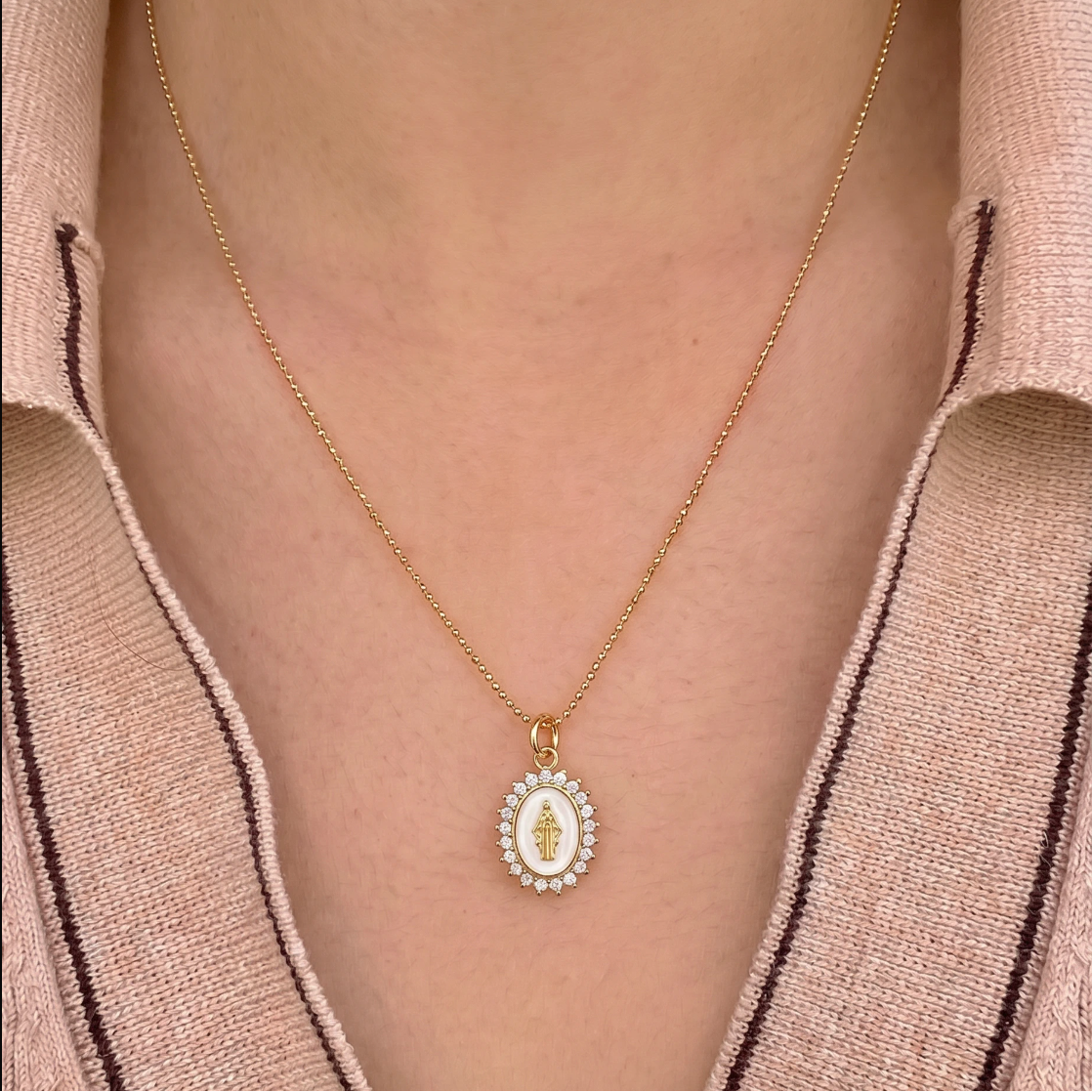 Mini Lady Lourdes white pendant necklace styled with gold jewelry